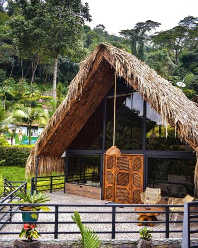 a straw hut with a thatched roof at Rancho Ecoturistico el Faro in La Mesa