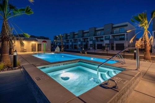 a swimming pool in front of a building at Zen Trail Retreat - New 5 bedroom luxury Condo in St. George