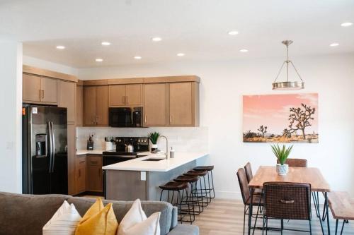 a kitchen and living room with a couch and a table at Zen Trail Retreat - New 5 bedroom luxury Condo in St. George