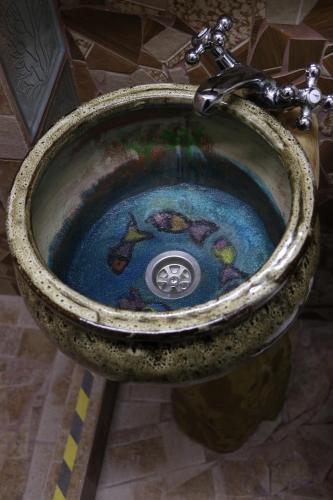 a bathroom sink with a painting on it at Casa Miliza - Agropensiunea şi Punctul Gastronomic Local, în vecinătatea castelului Salbek in Petriş