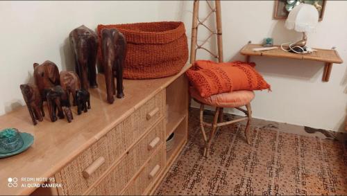 a wooden dresser in a room with a chair at La Gallina Nel Castello in Albenga