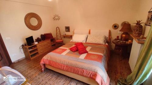 a bedroom with a bed with red pillows on it at La Gallina Nel Castello in Albenga