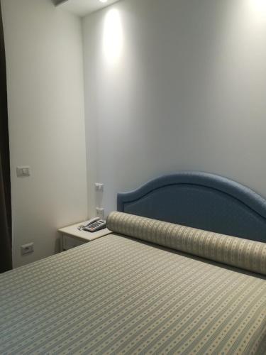 Postel nebo postele na pokoji v ubytování Hotel Flora