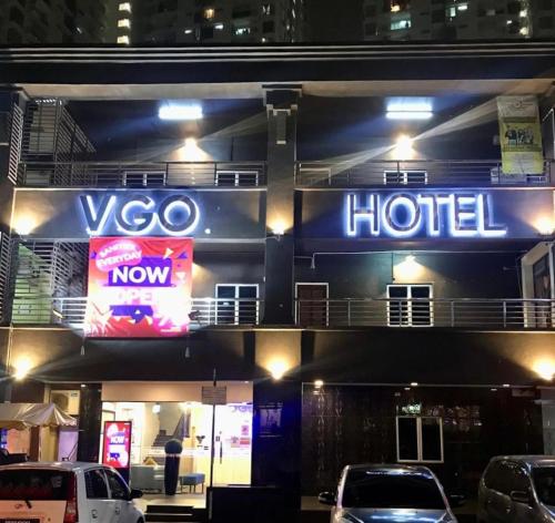 a hotel sign on the side of a building at night at Hotel VGO in Kuala Lumpur
