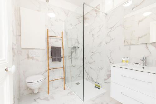 a white bathroom with a shower and a toilet at Maison Bianchi - Villefranche in Villefranche-sur-Mer