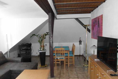a living room with a couch and a table at Ferienwohnungen Federleicht in Wermelskirchen