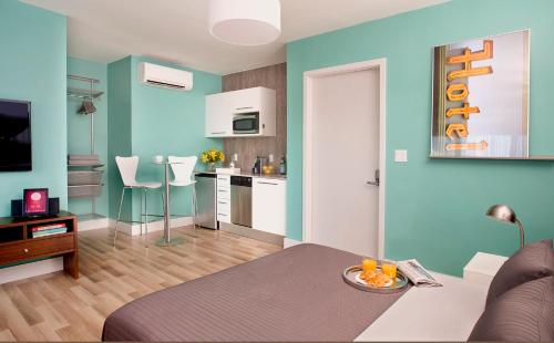 a living room with a couch and a kitchen at 1818 Meridian House Apartments and Suites by Eskape Collection in Miami Beach