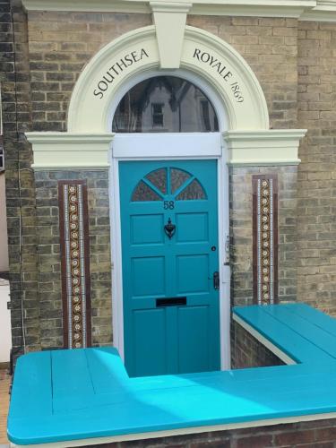 a blue front door of a house with a sign that reads sunvisornorne at Southsea Royale James Bond 3 bed Cool Penthouse, seafront parking in Portsmouth