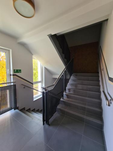 a staircase in a house with a mirror on the wall at ApartHome K8 Centrum Sulęcin in Sulęcin