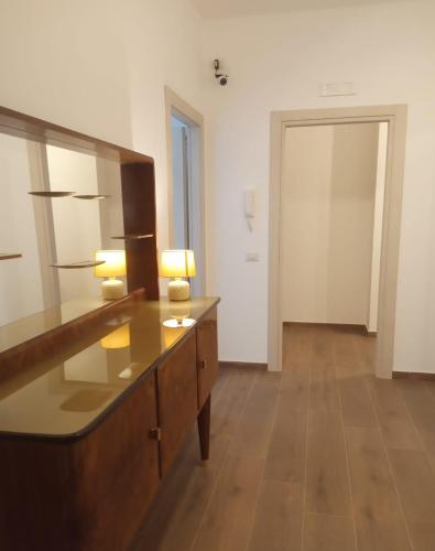 a room with a dresser with two lamps and a mirror at Residenze Sorrentino in Bari