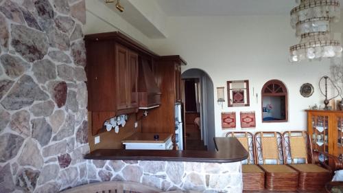a kitchen with a stone wall and a sink at Το πετρινο in Agia Marina Mikrolimanou