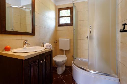 a bathroom with a sink and a toilet and a shower at Holiday Home Sandra in Sukošan