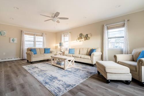 a living room with furniture and a ceiling fan at Spacious beach home ready for Family Memories! in Point Pleasant Beach