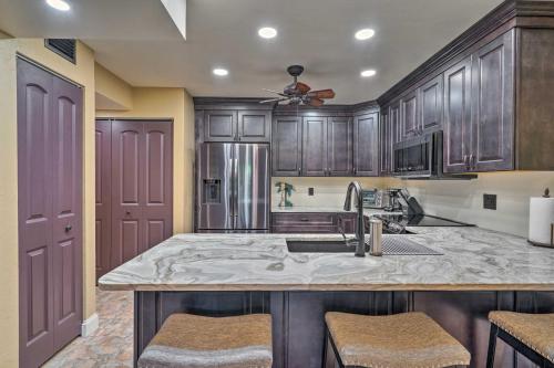 a kitchen with wooden cabinets and a sink at Chic Fort Myers Escape with Community Perks! in Fort Myers