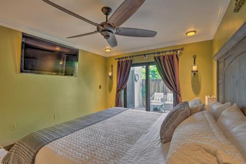 a bedroom with a large bed with a ceiling fan at Chic Fort Myers Escape with Community Perks! in Fort Myers