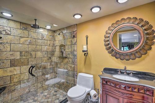 a bathroom with a toilet and a sink and a mirror at Chic Fort Myers Escape with Community Perks! in Fort Myers
