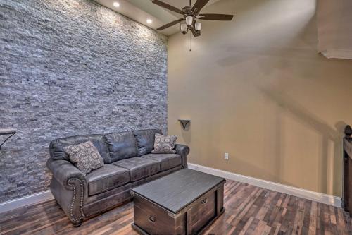 a living room with a couch and a brick wall at Chic Fort Myers Escape with Community Perks! in Fort Myers