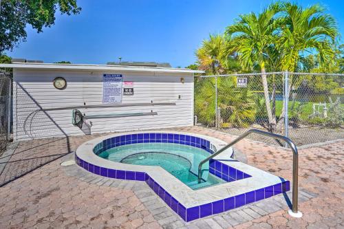 a hot tub with blue tiles in a yard at Chic Fort Myers Escape with Community Perks! in Fort Myers