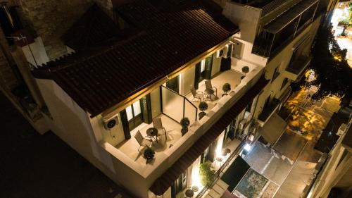 an overhead view of a building with a balcony with plants at Pandrosos Divine Suites in Athens
