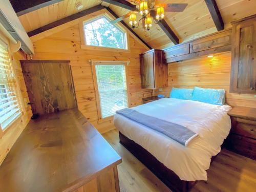a bedroom with a bed in a wooden cabin at B10 NEW Awesome Tiny Home with AC Mountain Views Minutes to Skiing Hiking Attractions in Carroll