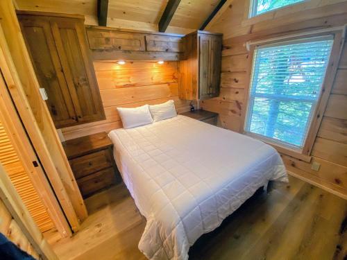 a bedroom with a bed in a wooden cabin at B2 NEW Awesome Tiny Home with AC Mountain Views Minutes to Skiing Hiking Attractions in Carroll