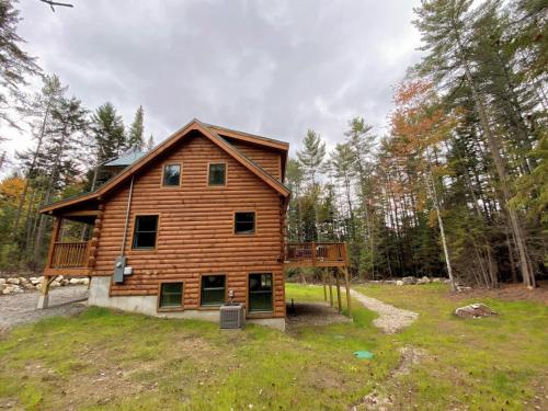 a log cabin in the middle of a field at Brand New Log Home Well appointed great location with AC wifi cable fireplace firepit in Bethlehem
