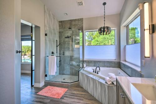 a bathroom with a tub and a shower and a sink at Putting Green Golfers Getaway in Scottsdale in Scottsdale