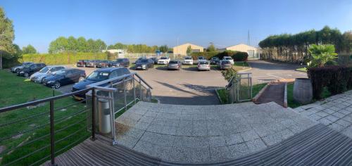 a skateboard ramp in a parking lot with parked cars at Hôtel Le Forestia in Pannes