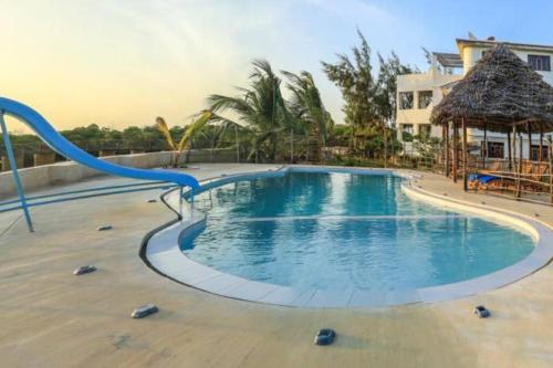 a swimming pool with a slide in a resort at MANDA ISLAND Private Villa in Lamu