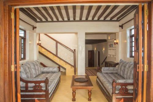 a living room with two couches and a table at MANDA ISLAND Private Villa in Lamu