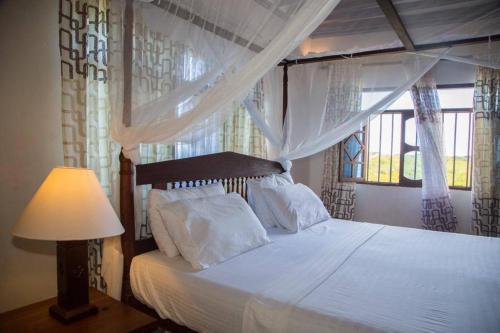 En eller flere senger på et rom på MANDA ISLAND Private Villa