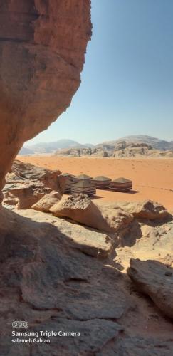 a view of a desert with a building in the distance at bedouin future camp in Wadi Rum