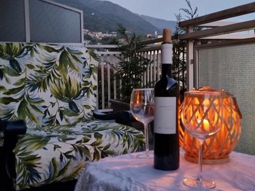 a bottle of wine sitting on a table with a glass at Mary House in Sondrio
