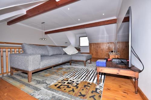 a living room with a couch and a table at Cyprus Manor 12 in Mossel Bay