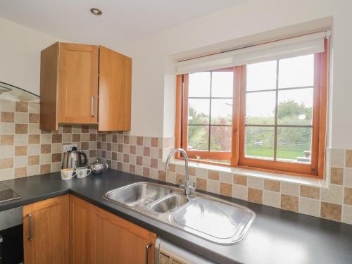 a kitchen with a sink and a window at Avon View in Stratford-upon-Avon