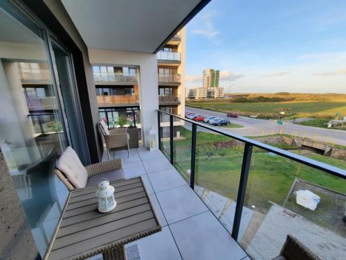 a balcony with a table and a view of a street at Apartament 10 Glamour Aquapark Reda in Reda