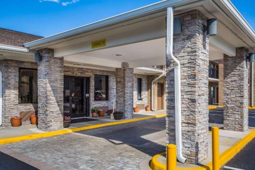 a brick building with yellow accents on a street at Quality Inn & Suites in Suffolk