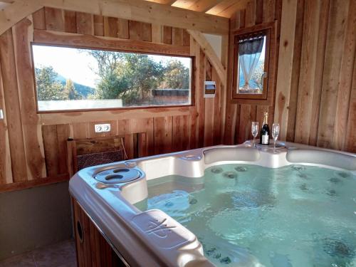 a jacuzzi tub in a cabin with a window at Gite de Champ Chaulier in Crots