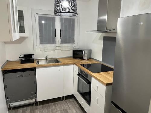 a small kitchen with a sink and a refrigerator at New&Cosy - Near Disney/Paris - 100m RER A in Lognes