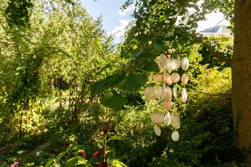 a tree with white flowers in a garden at Hotel Atlas in České Budějovice