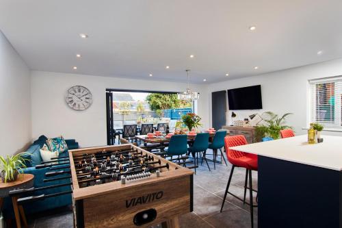 a living room with a large chess board in the middle at Meadow Cott in Milford on Sea