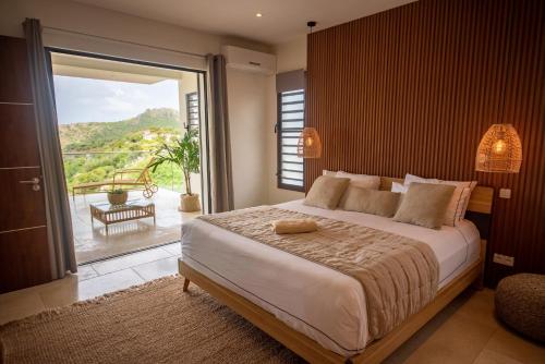 מיטה או מיטות בחדר ב-Les villas de Sweet Hill