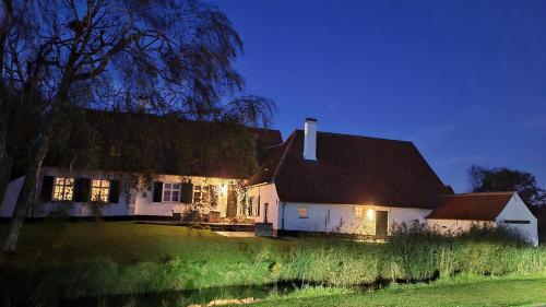 a white house with christmas lights on it at Hoeve Spyckergoed in De Haan