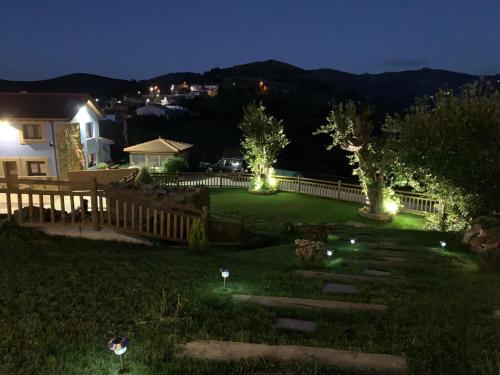 a backyard at night with lights in the grass at La Salina - Complejo Turistico Rural CaleaCabo in Biescas