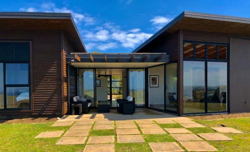 a house with glass doors and a patio at Te Kahu Pacific View in Whangarei