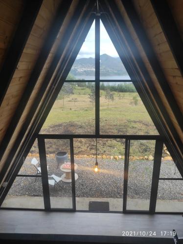 a window in a room with a view of a field at Refugio El Cacique in Guatavita