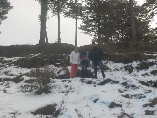 a group of three people standing in the snow at Neha Homestay in Shimla