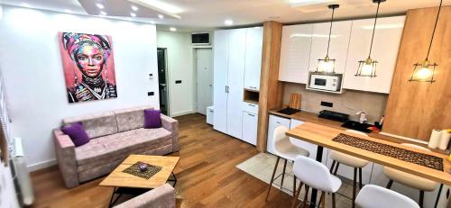a living room with a couch and a table at MOON LUX Apartman Beograd in Belgrade