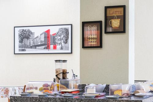 a table with food on it with pictures on the wall at Hospedaria Santo André in Sao Paulo