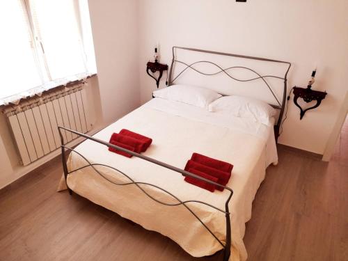 a bedroom with a large white bed with red pillows at Cava Resort Costa d'Amalfi in San Pietro